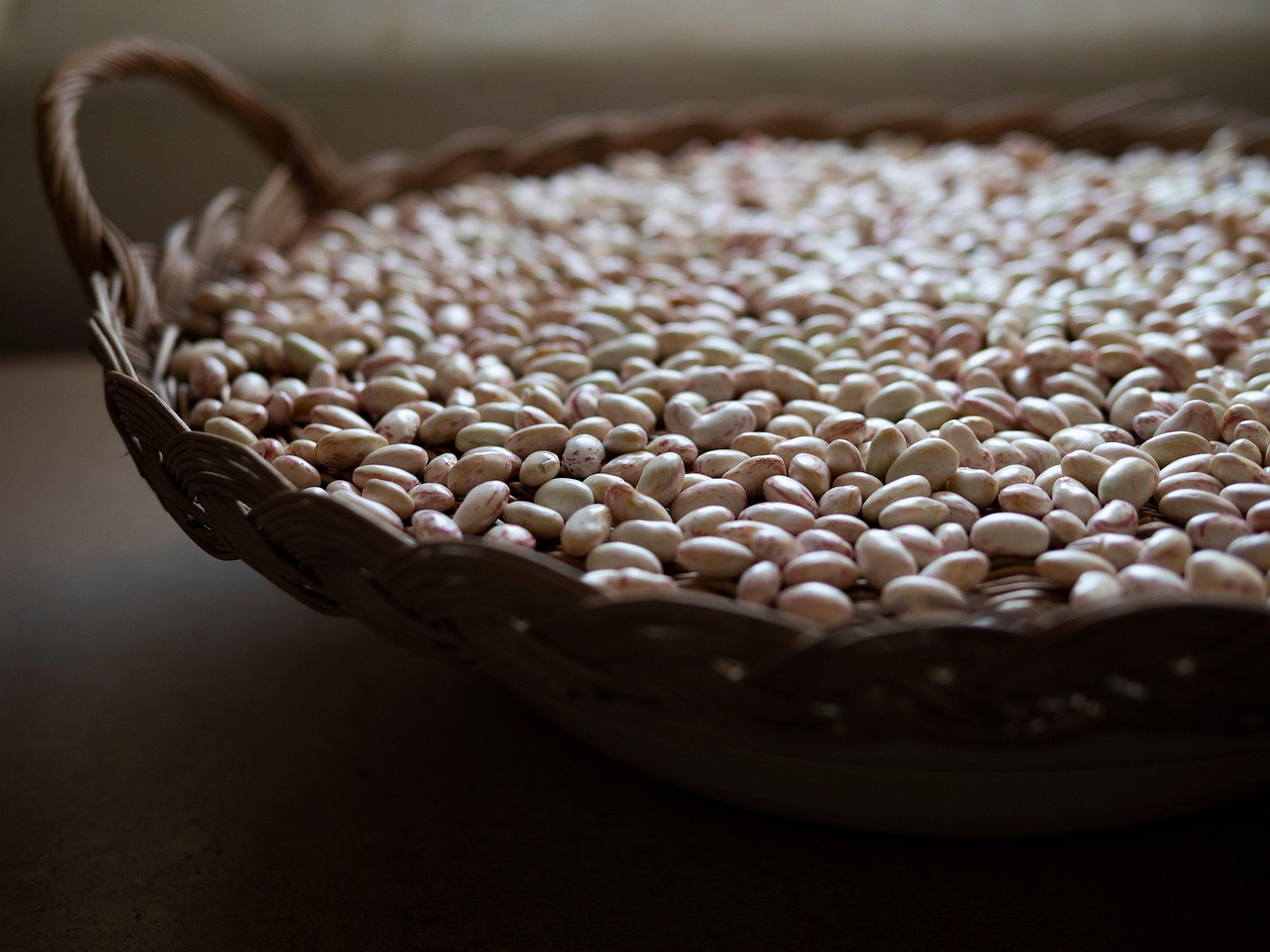 Piatto di pasta e fagioli servito in una ciotola, decorato con rosmarino fresco.